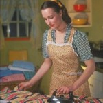 Contented Housewife in Apron Ironing